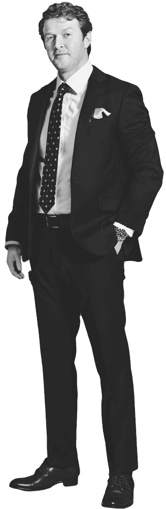 Attorney Aaron Burke standing in a suit. It's a black and white image.