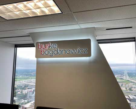 Burke Bogdanowicz PLLC signage backlit and hanging from the ceiling.